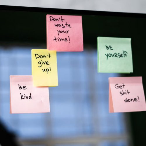 Colorful sticky notes on a mirror provide daily motivational messages and positivity reminders.